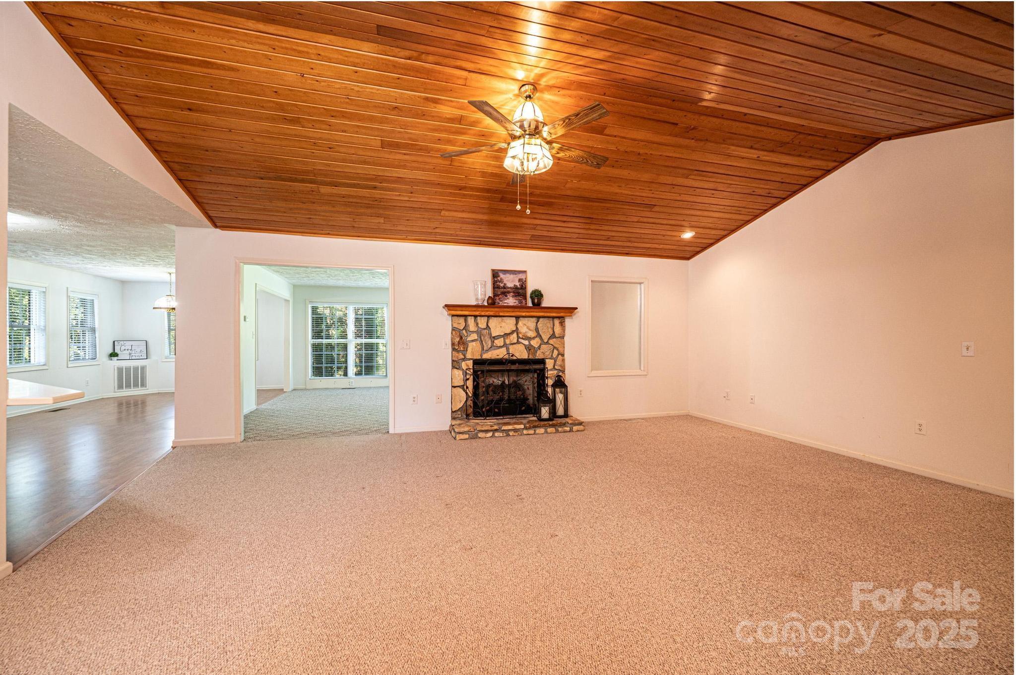 227 Robert Keever Road Stanley, NC 28164 - Photo 18 of 45 a view of an empty room with a fireplace and a chandelier