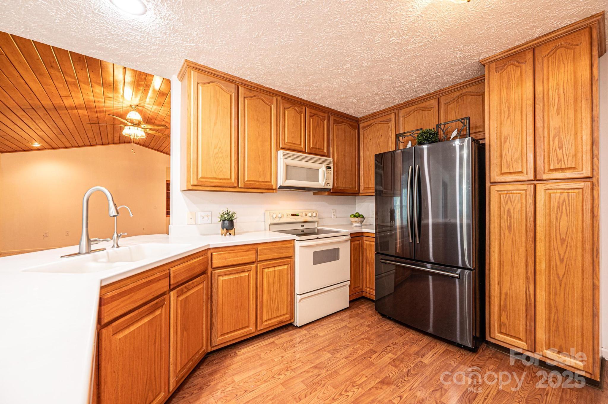 227 Robert Keever Road Stanley, NC 28164 - Photo 20 of 45 a kitchen with stainless steel appliances granite countertop a refrigerator sink and microwave