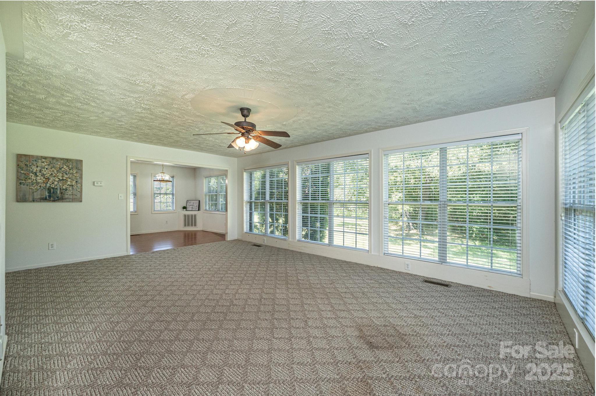 227 Robert Keever Road Stanley, NC 28164 - Photo 22 of 45 a view of a livingroom with a ceiling fan and window