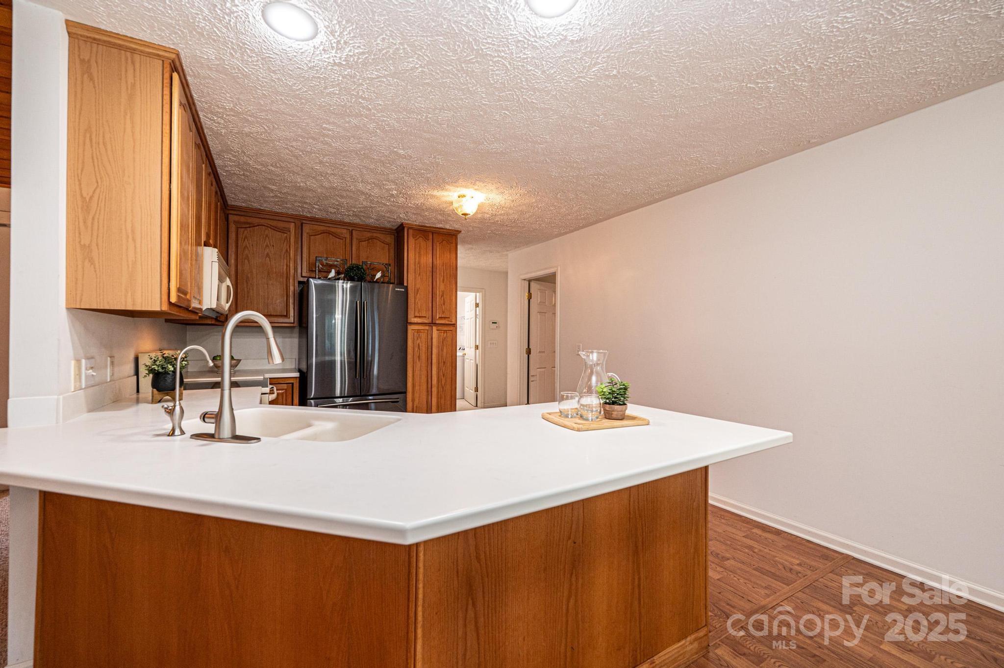 227 Robert Keever Road Stanley, NC 28164 - Photo 25 of 45 a kitchen with stainless steel appliances a sink and a refrigerator