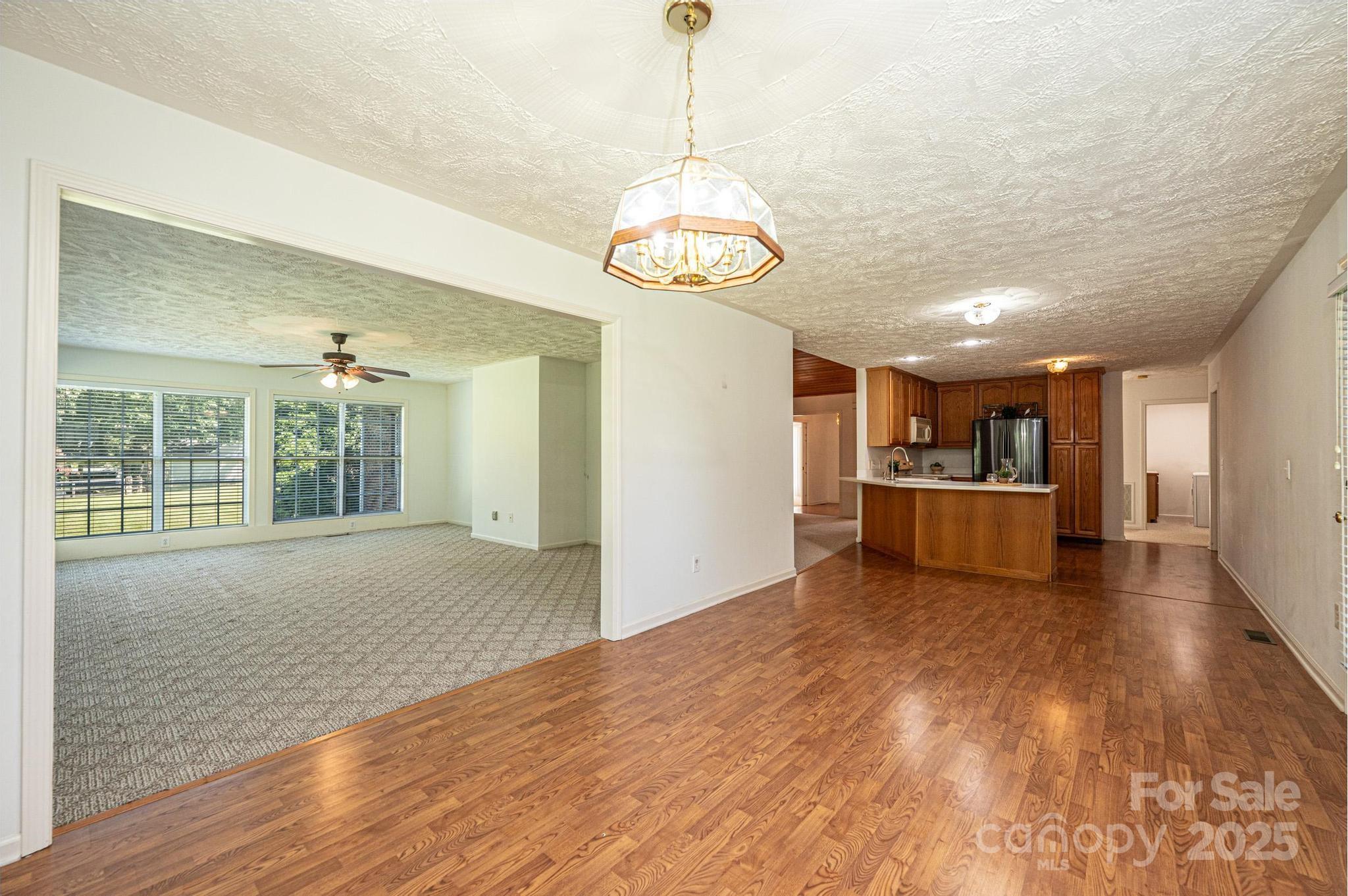 227 Robert Keever Road Stanley, NC 28164 - Photo 27 of 45 a view of an empty room with window and wooden floor