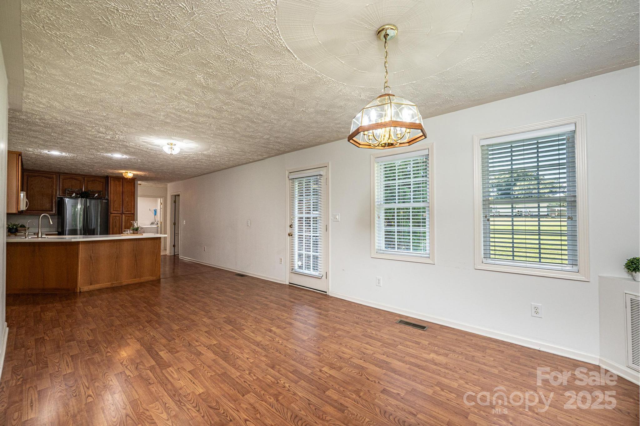 227 Robert Keever Road Stanley, NC 28164 - Photo 28 of 45 a view of an empty room with window and wooden floor