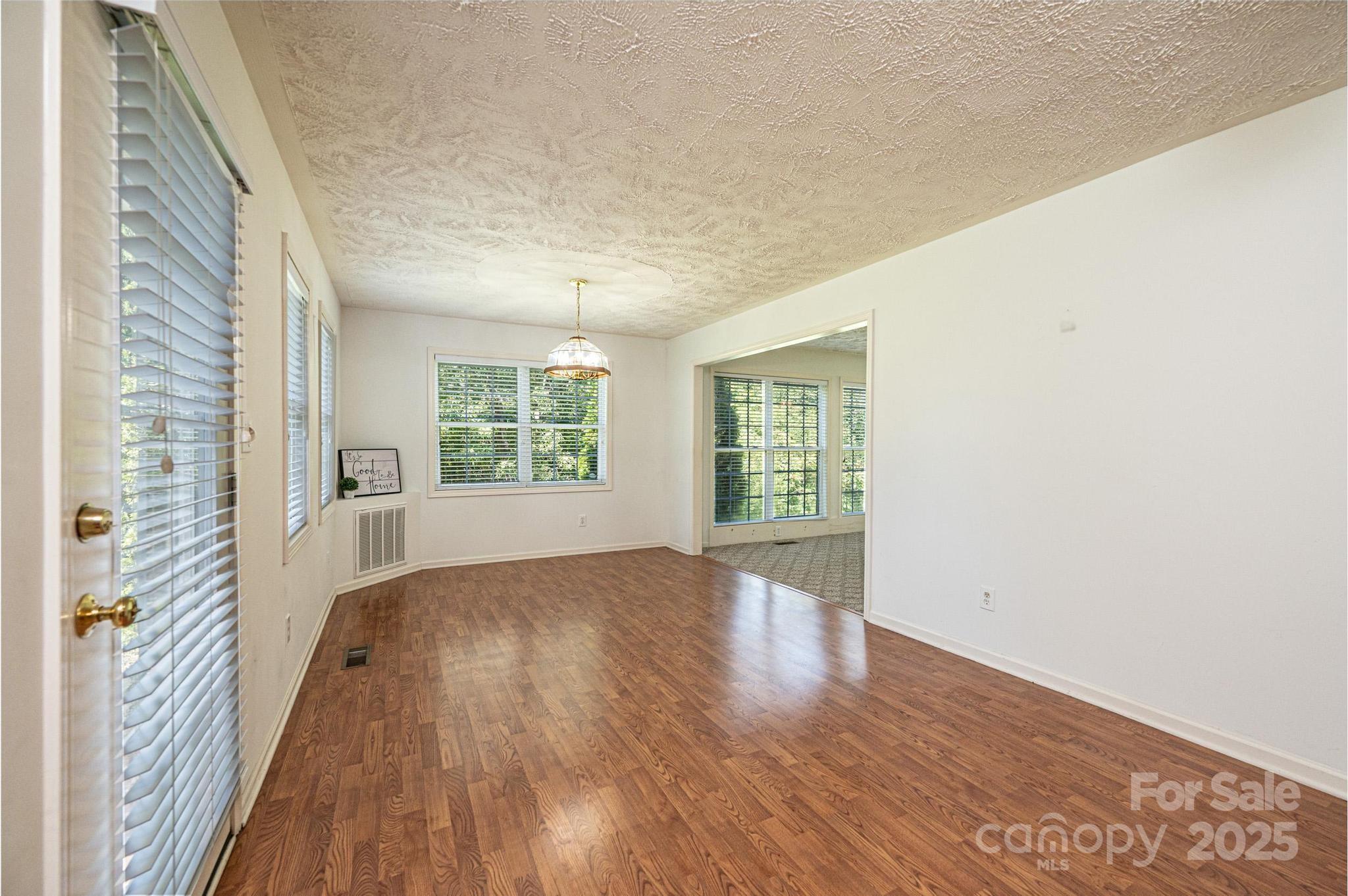 227 Robert Keever Road Stanley, NC 28164 - Photo 30 of 45 a view of an empty room with wooden floor and a window