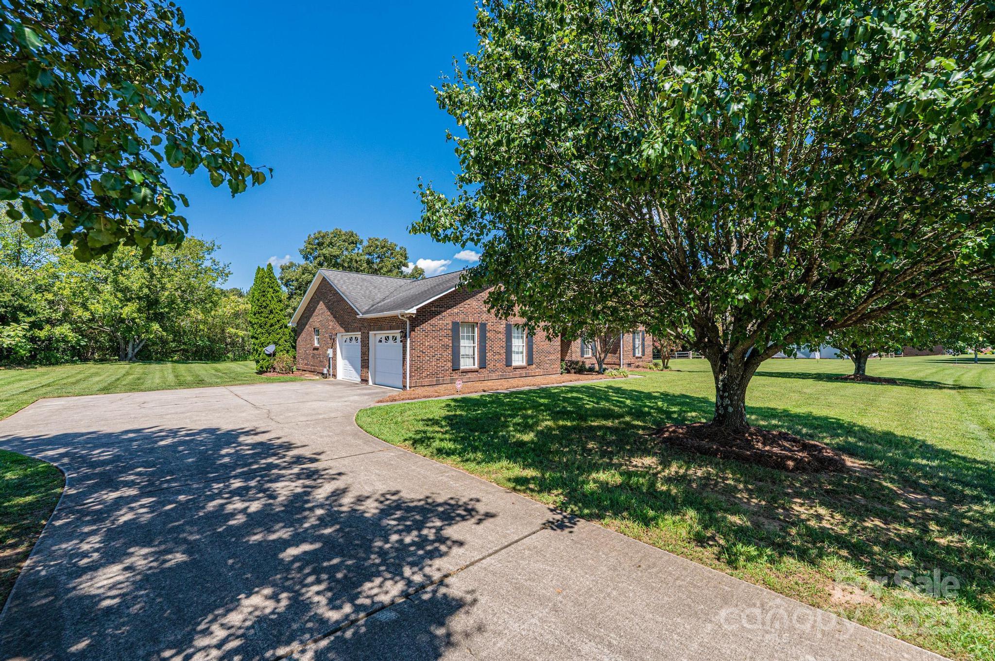 227 Robert Keever Road Stanley, NC 28164 - Photo 3 of 45 a front view of a house with a garden