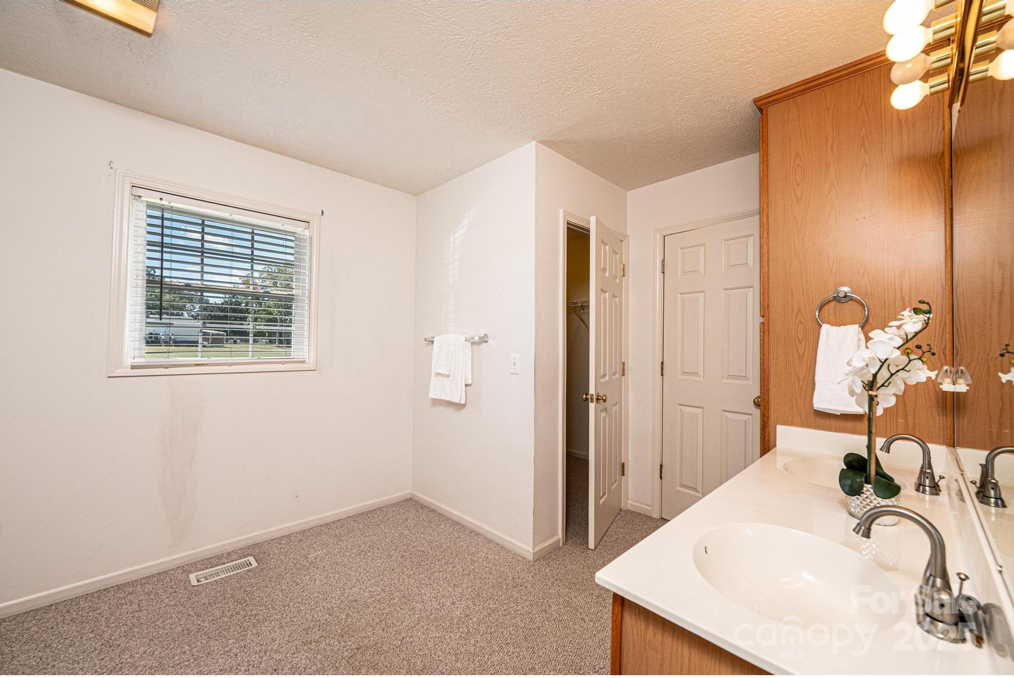 227 Robert Keever Road Stanley, NC 28164 - Photo 38 of 45 a bathroom with a sink and a mirror
