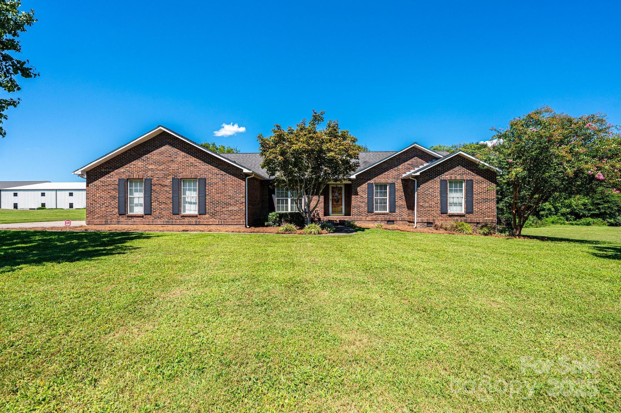 227 Robert Keever Road Stanley, NC 28164 - Photo 6 of 45 a front view of a house with garden