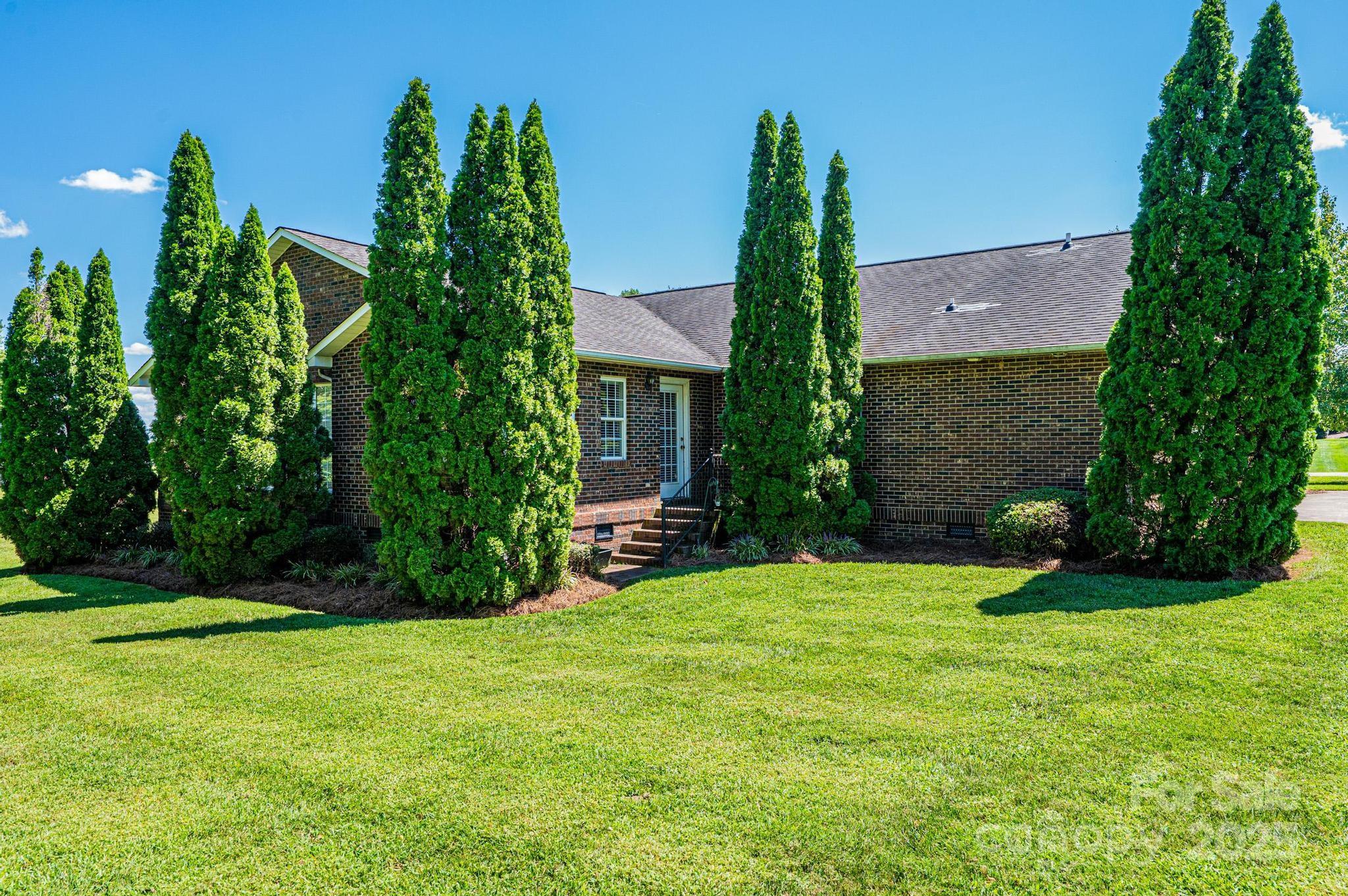 227 Robert Keever Road Stanley, NC 28164 - Photo 8 of 45 a view of a house with a yard and tree s