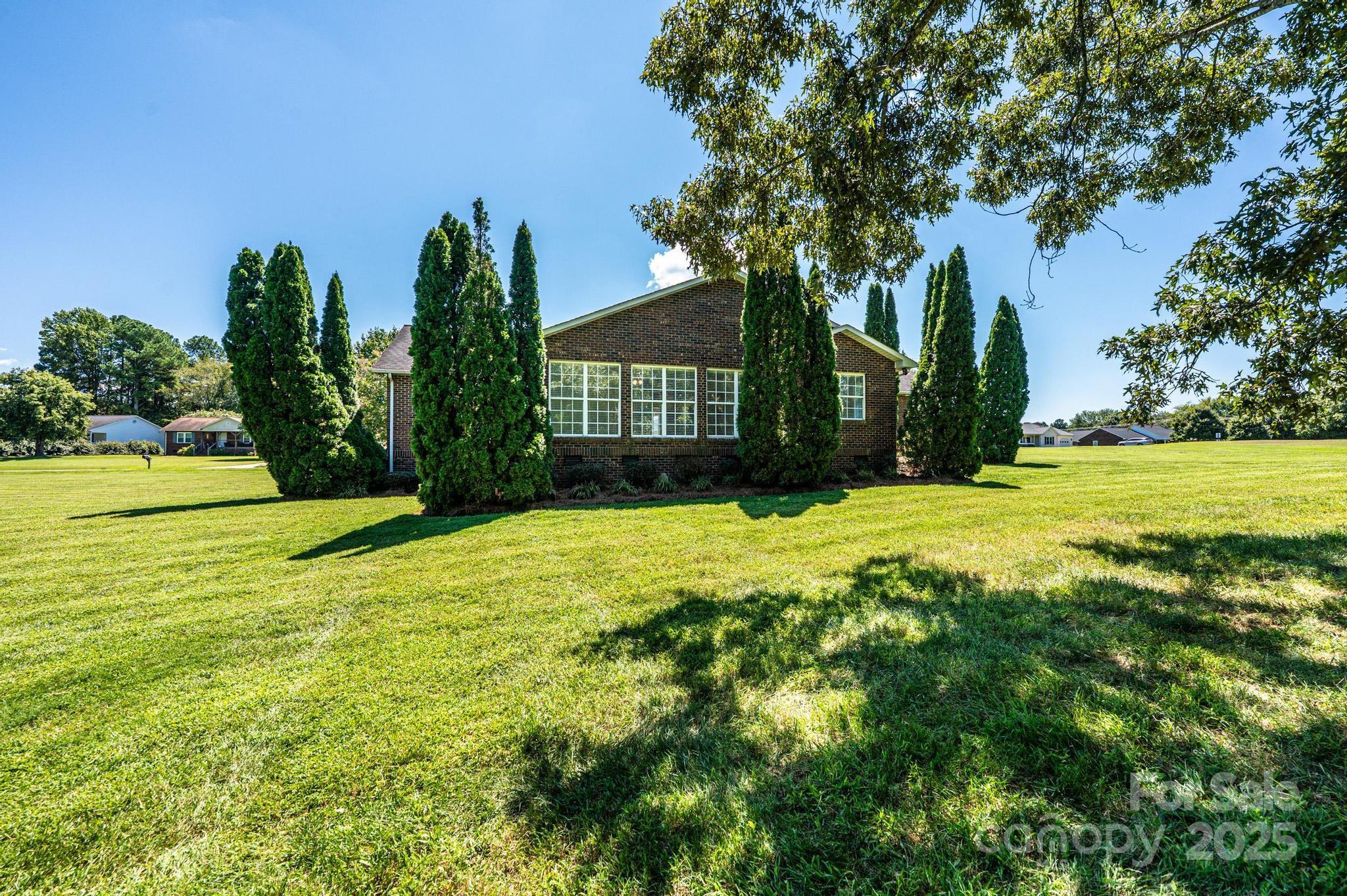 227 Robert Keever Road Stanley, NC 28164 - Photo 9 of 45 a view of a yard with palm trees