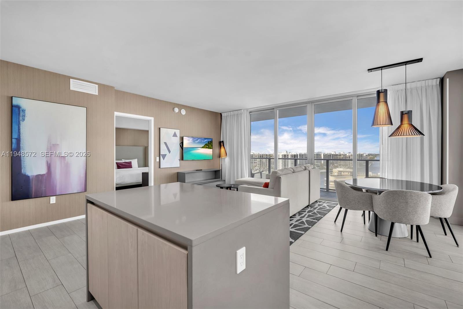 4010 South Ocean Drive, Unit R701 Hollywood, FL 33019 - Photo 11 of 46 a kitchen with a table chairs stove and wooden floor