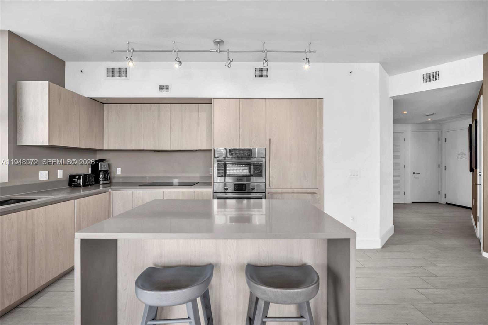 4010 South Ocean Drive, Unit R701 Hollywood, FL 33019 - Photo 13 of 46 a kitchen with a table chairs stove and cabinets