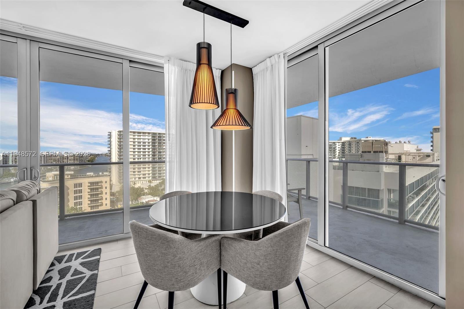 4010 South Ocean Drive, Unit R701 Hollywood, FL 33019 - Photo 14 of 46 a dining room with furniture and a floor to ceiling window