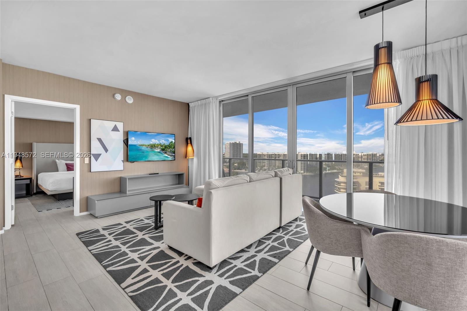 4010 South Ocean Drive, Unit R701 Hollywood, FL 33019 - Photo 15 of 46 a living room with furniture and a large window