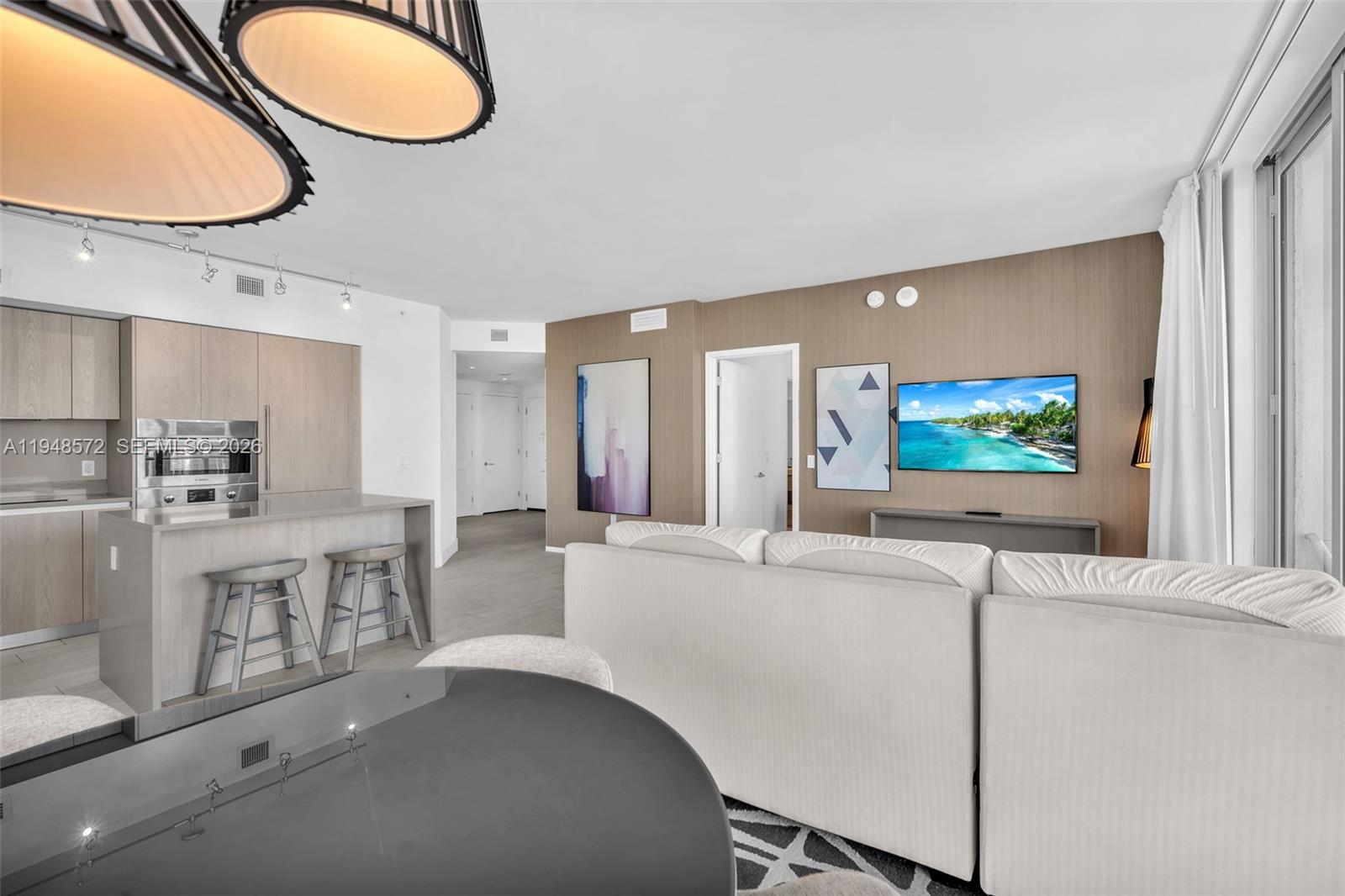 4010 South Ocean Drive, Unit R701 Hollywood, FL 33019 - Photo 16 of 46 a large white kitchen with a large window a sink and a stainless steel appliances