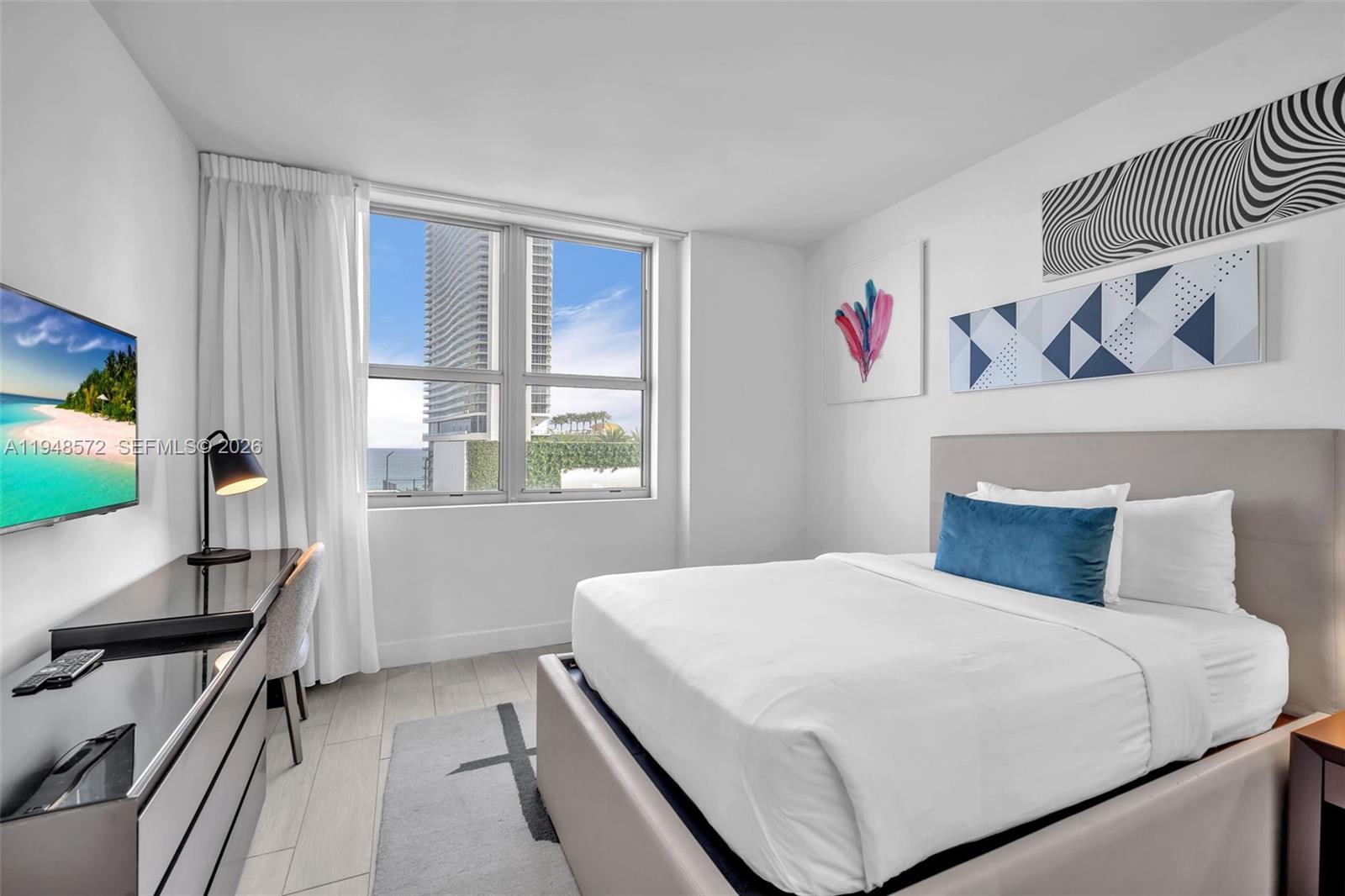 4010 South Ocean Drive, Unit R701 Hollywood, FL 33019 - Photo 17 of 46 a bedroom with a bed and a flat screen tv