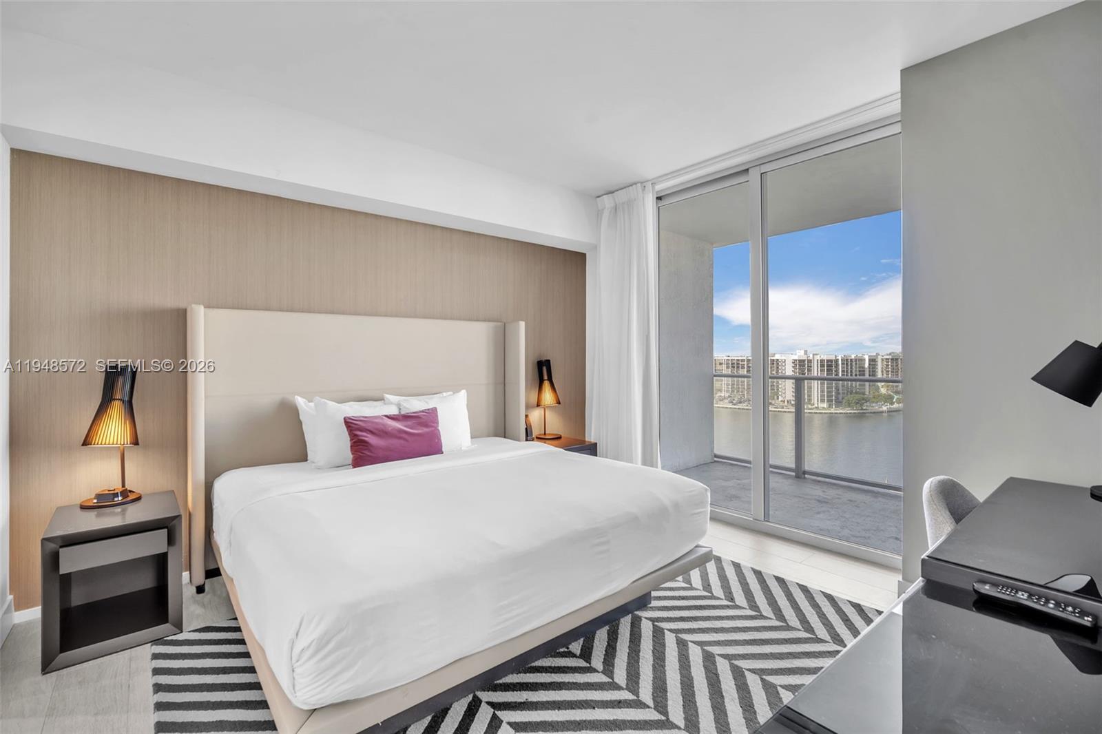 4010 South Ocean Drive, Unit R701 Hollywood, FL 33019 - Photo 20 of 46 a bedroom with a bed and wooden floor