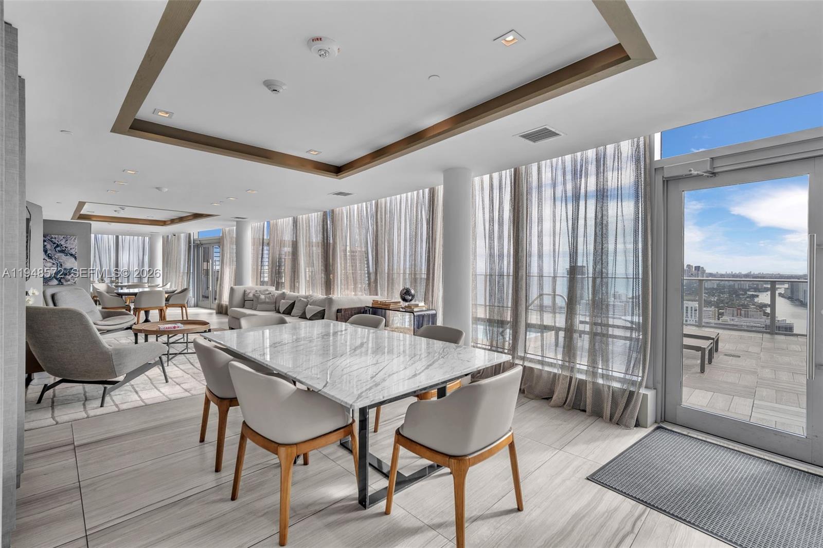 4010 South Ocean Drive, Unit R701 Hollywood, FL 33019 - Photo 32 of 46 a dining room with furniture and a floor to ceiling window