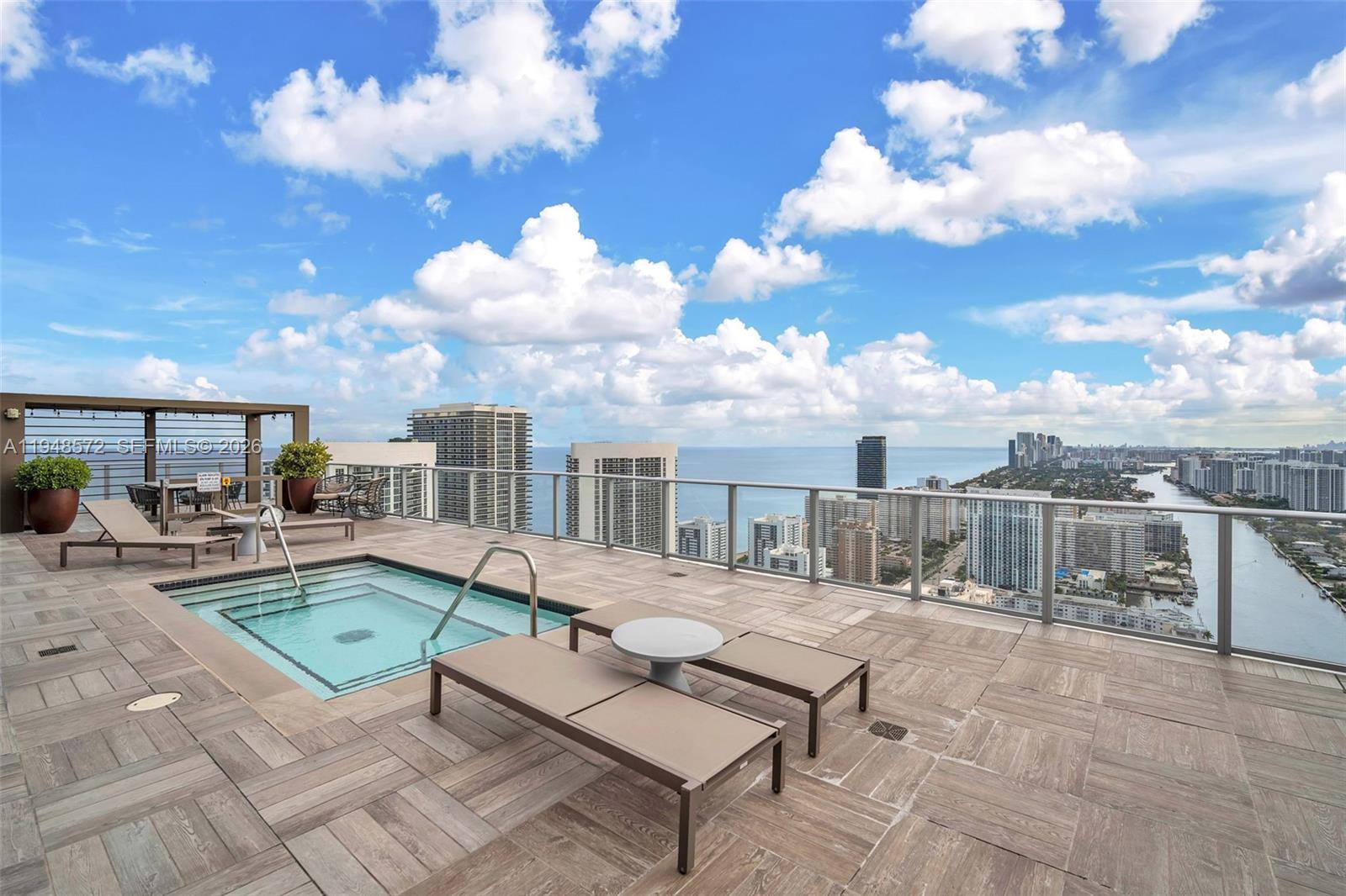 4010 South Ocean Drive, Unit R701 Hollywood, FL 33019 - Photo 34 of 46 a view of a patio with swimming pool table and chairs