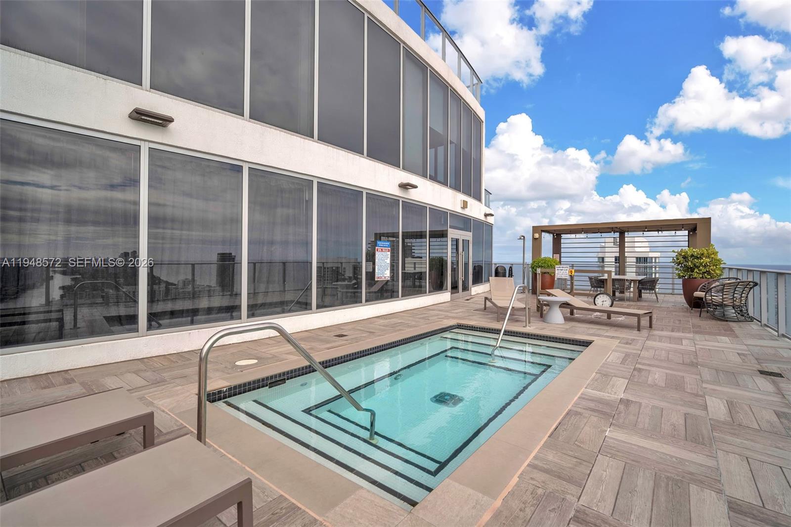 4010 South Ocean Drive, Unit R701 Hollywood, FL 33019 - Photo 37 of 46 a view of a patio with couches table and chairs and potted plants