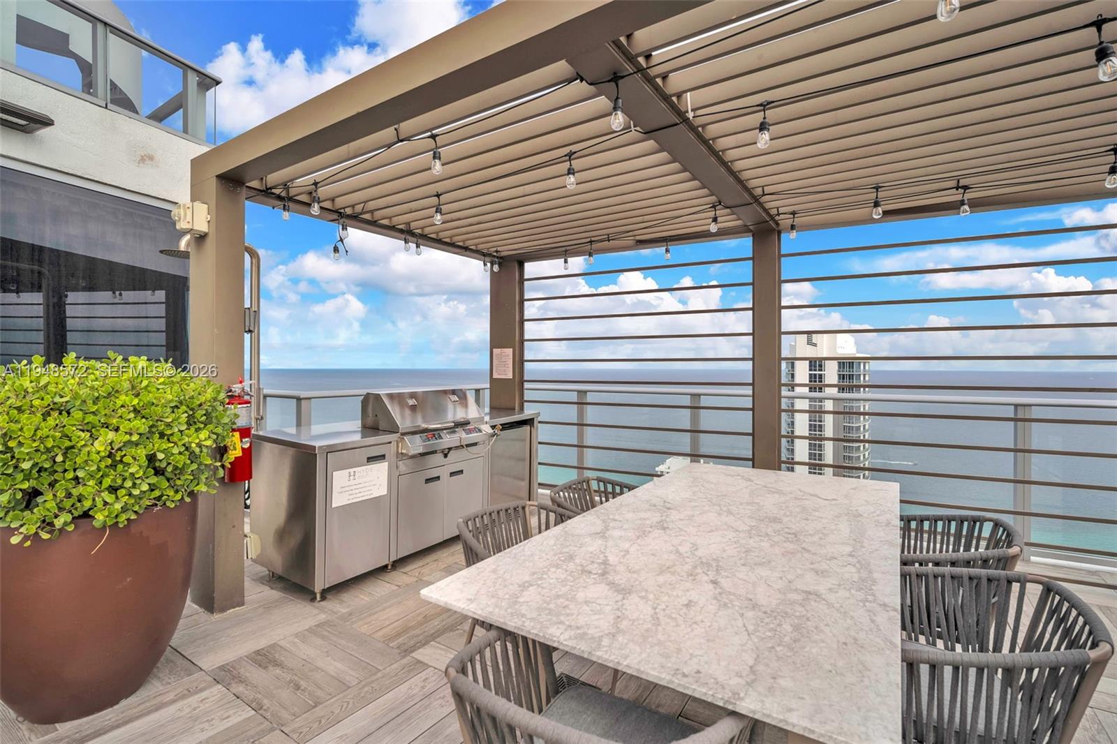 4010 South Ocean Drive, Unit R701 Hollywood, FL 33019 - Photo 38 of 46 a balcony with furniture and potted plants