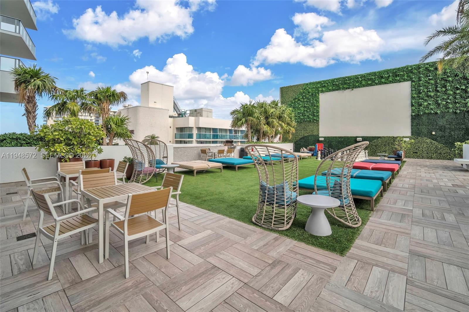 4010 South Ocean Drive, Unit R701 Hollywood, FL 33019 - Photo 40 of 46 a view of a chairs and table in backyard of the house