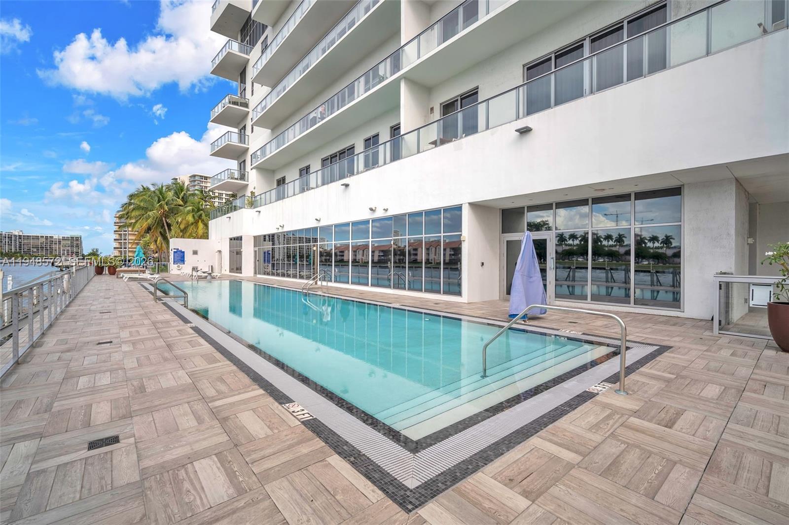 4010 South Ocean Drive, Unit R701 Hollywood, FL 33019 - Photo 44 of 46 a view of backyard with swimming pool and outdoor seating