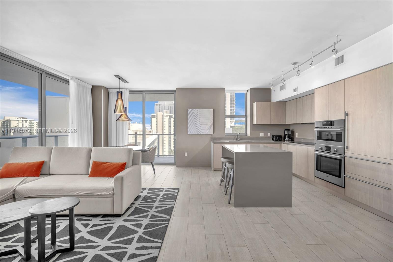 4010 South Ocean Drive, Unit R701 Hollywood, FL 33019 - Photo 7 of 46 a living room with stainless steel appliances furniture and a kitchen view
