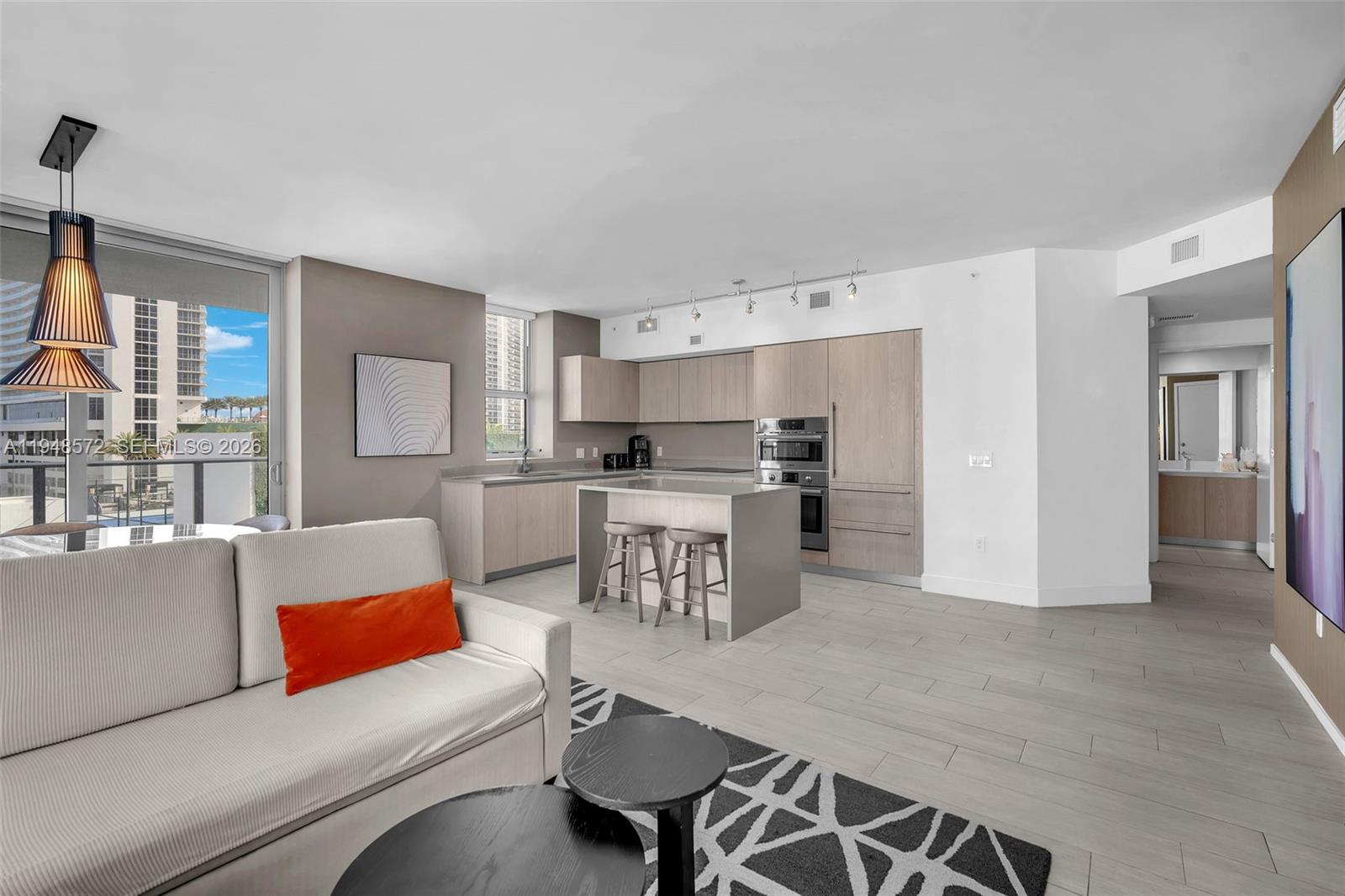 4010 South Ocean Drive, Unit R701 Hollywood, FL 33019 - Photo 8 of 46 a living room with furniture and a table