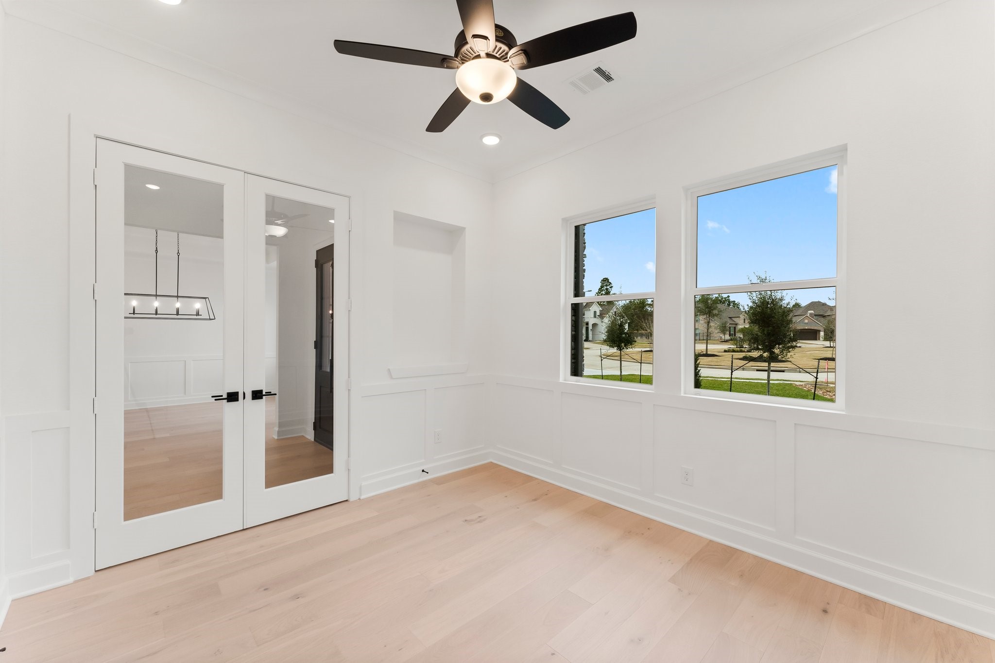 7315 Julie Pond Lane Spring, TX 77389 - Photo 7 of 48 Bright study features a ceiling fan and glass double doors, offering a modern and inviting space.