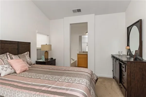 a bedroom with a bed and a mirror