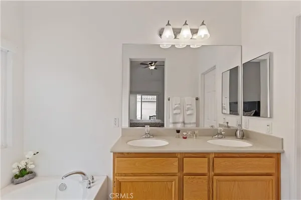 a bathroom with a sink vanity and a mirror