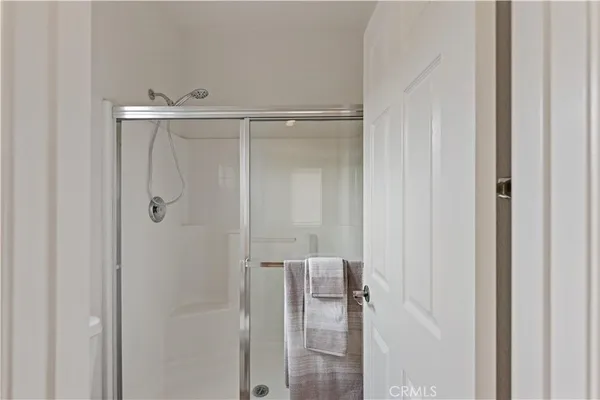 a bathroom with a glass shower door