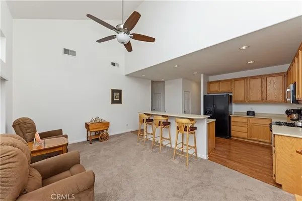 a living room with furniture and kitchen view