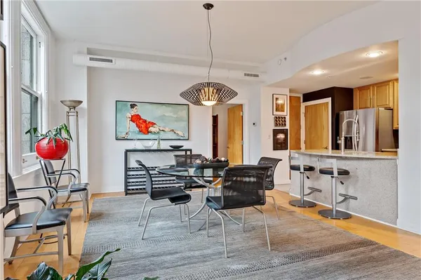 a view of a dining room with furniture wooden floor and chandelier