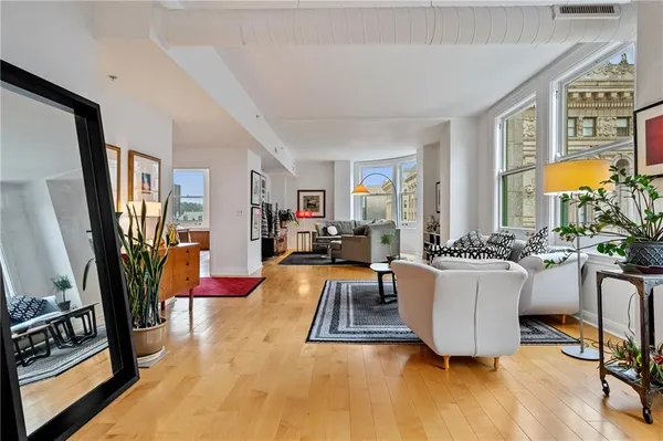 a living room with furniture a flat screen tv and a table
