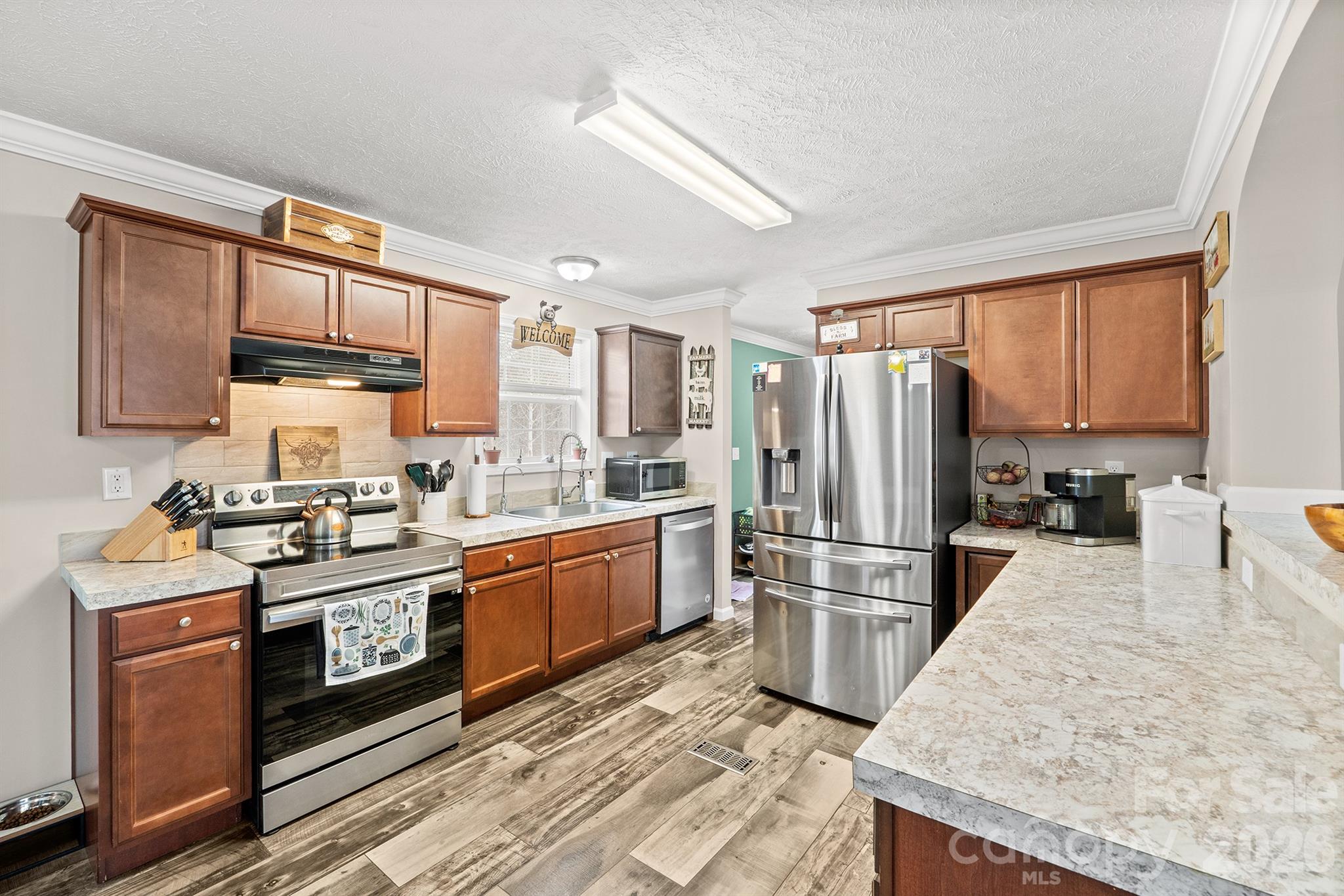 119 Marietta Road Mooresville, NC 28117 - Photo 11 of 38 a kitchen with stainless steel appliances granite countertop a stove a sink dishwasher a refrigerator and cabinets with wooden floor