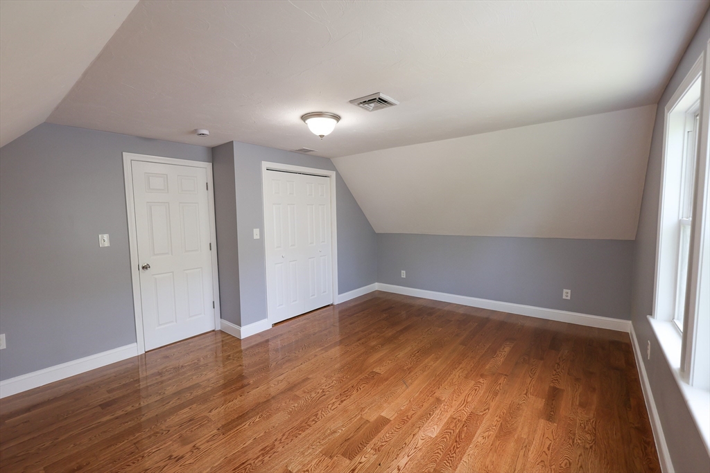 70 Mt Hope Street, Unit 2 Boston, MA 02131 - Photo 13 of 19 wooden floor in an empty room with a window