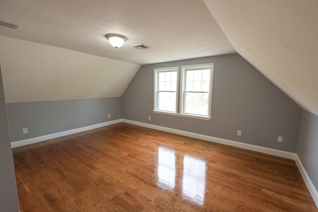 70 Mt Hope Street, Unit 2 Boston, MA 02131 - Photo 17 of 19 a view of empty room with wooden floor and fan