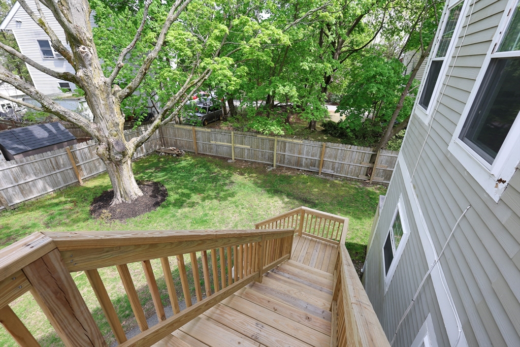 70 Mt Hope Street, Unit 2 Boston, MA 02131 - Photo 19 of 19 a view of balcony with wooden floor and fence
