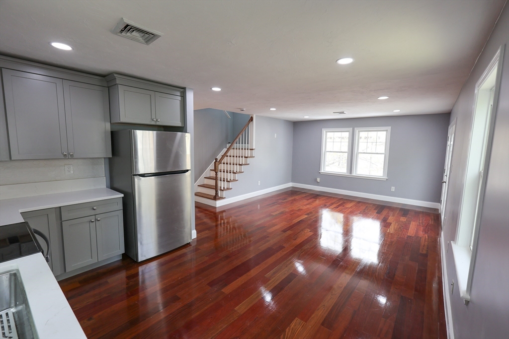 70 Mt Hope Street, Unit 2 Boston, MA 02131 - Photo 3 of 19 a view of empty room with wooden floor and window