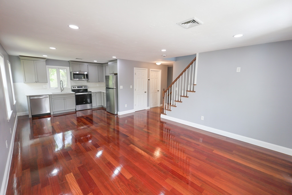 70 Mt Hope Street, Unit 2 Boston, MA 02131 - Photo 5 of 19 a view of kitchen and dining room with wooden floor