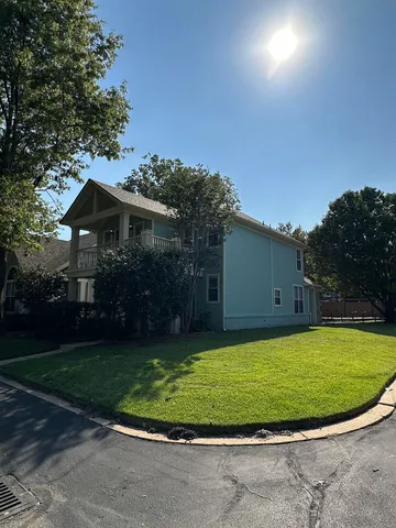 a view of a house with a swimming pool and a yard