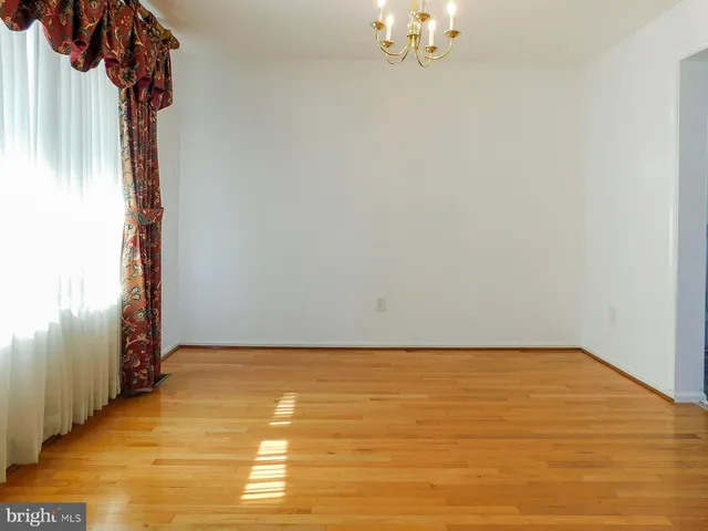 a kitchen with stainless steel appliances granite countertop a sink a stove and a wooden floors