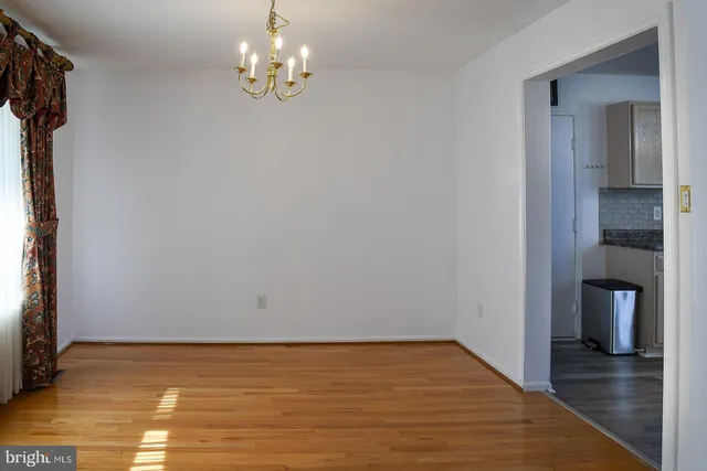 a kitchen with a sink stove and wooden floor