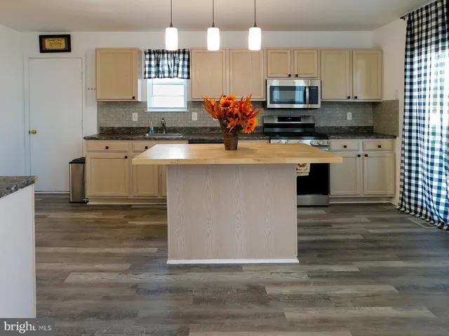 an empty room with windows and fireplace