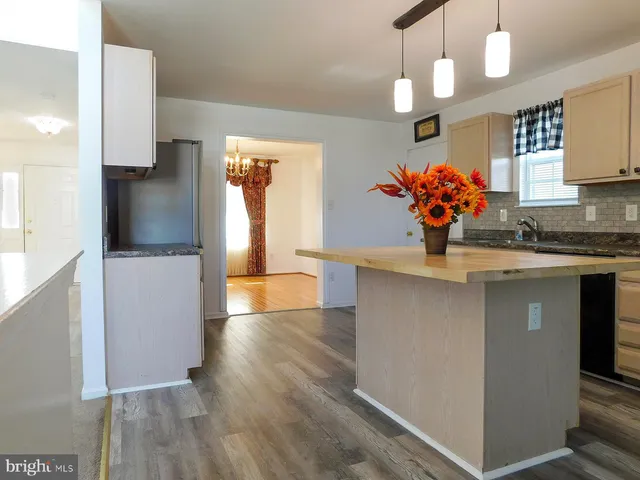 a view of an entryway and hall with a front door