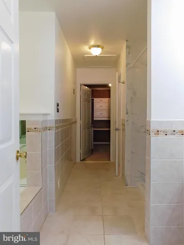 an empty room with wooden floor fireplace and windows