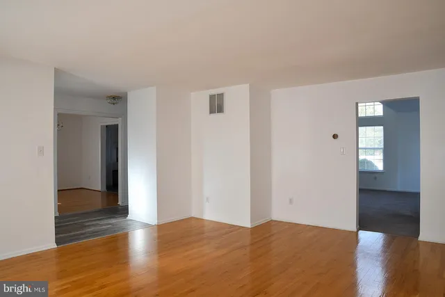 a kitchen with stainless steel appliances granite countertop a stove a sink and white cabinets
