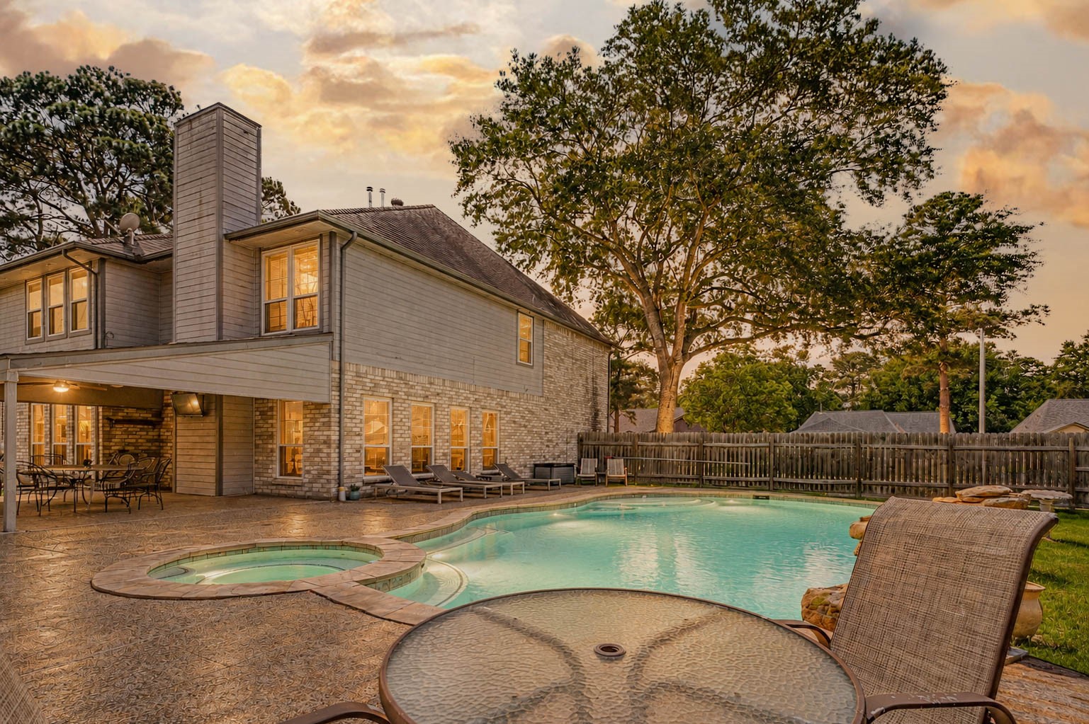 9215 Landry Boulevard Spring, TX 77379 - Photo 2 of 42 The expansive backyard retreat features a massive saltwater pool and spa surrounded by generous green space, and a private setting. Take note of the towering trees in the front yard!