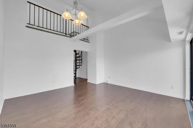 a view of a balcony with chairs and a potted plant