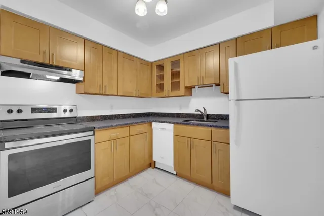 a kitchen with stainless steel appliances granite countertop a stove and a refrigerator